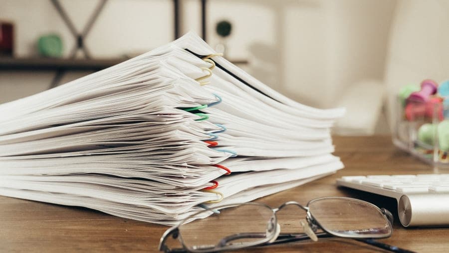 A stack of reference documents on a desk