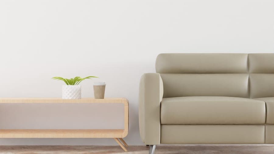 A living room with a sofa, rug and large window