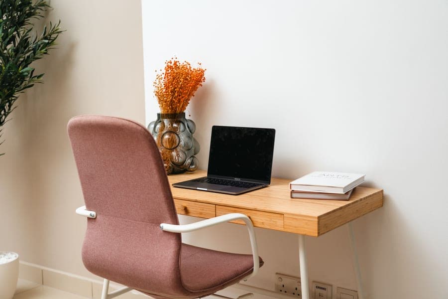 A cozy small home office desk in a corner